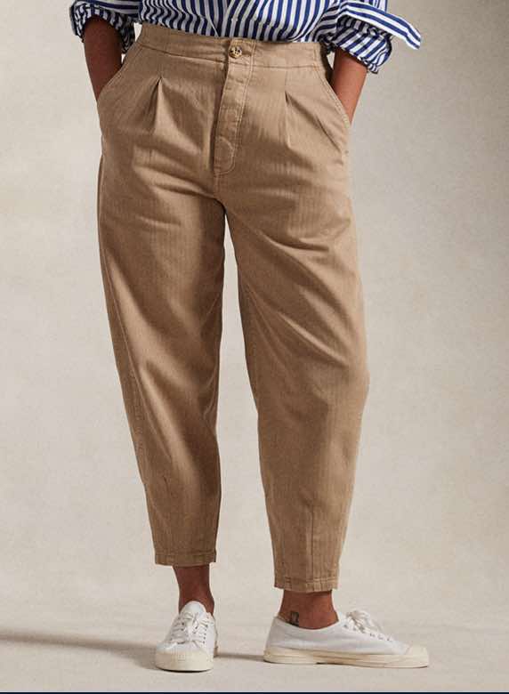 Photograph of woman in tapered chino pants.
